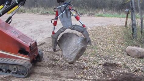 moving 24 inch rocks with a skid steer|how to move rock pipes.